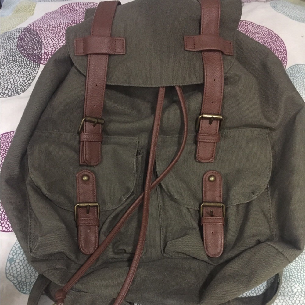 Olive green backpack faux brown leather details